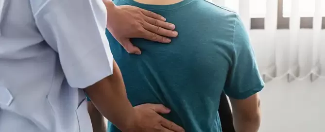 man holding his back